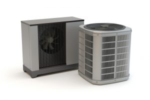 Two heat pump units side by side, prepared for installation on a flat surface. 
