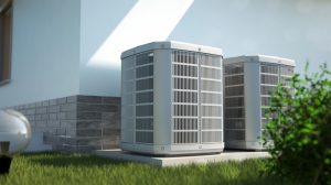 Two outdoor AC units next to a house, on a concrete pad, with green grass around them, ready for maintenance.
